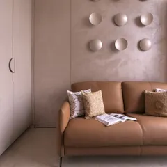 This bedroom is an exercise in soft luxury. I used a palette of grounded neutrals and sculpted textures, like the backlit concave discs on the wall, to create a space that feels both artistic and deeply calming.