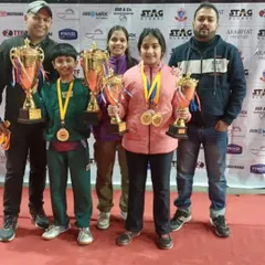 A proud moment for our players and coaches at the Delhi State Table Tennis Championship. Arunim and Akanksha Singhal stand with their coaches, holding multiple trophies from a successful tournament where they won gold in several individual and team events.