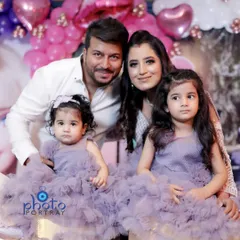 A classic family portrait with parents and their two young daughters dressed in matching purple dresses. I make sure to get these posed shots for you to frame and cherish.