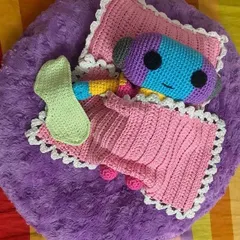 An overhead view of the Zeno doll sleeping with his handmade accessories. It was a fun challenge to create a whole little bed set for him.