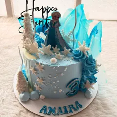 Let it go! This Frozen-themed cake is perfect for any little Elsa fan. I used shades of blue, edible snowflakes, and sugar shards that look like ice to create a winter wonderland.