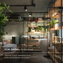 The FCML Sanitary experience centre in Hyderabad, where luxury is redefined through an industrial-chic aesthetic. The design uses raw textures, metal shelving, and lush greenery to create a unique and memorable showroom.