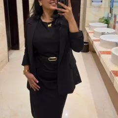 A classic corporate look featuring a black dress and blazer. This mirror selfie shows a go-to professional outfit that is both sharp and stylish for any business event.