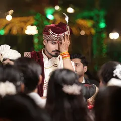 A powerful, candid shot of the groom during the wedding ceremony, capturing a moment of intense emotion and anticipation.