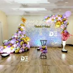 This iridescent sequin panel served as a dazzling backdrop for a party. I framed it with a balloon garland in pastel purple, silver, and gold, creating a fun and festive photo zone for guests.