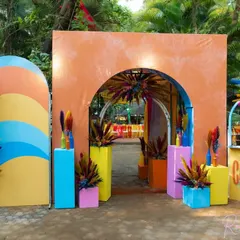 Another view of the colorful carnival entrance, showcasing the layered arches and playful decor elements that welcomed guests to the party.