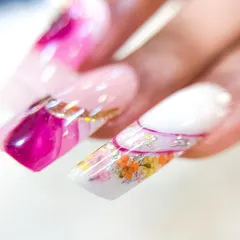 This image shows the floral inbuilt nail alongside other abstract designs, demonstrating how to create a cohesive yet varied full set.