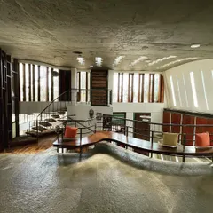 We believe buildings can talk, especially through the interplay of light and form. Here, sunlight streams through carefully placed openings, interacting with the home's organic, flowing structure to create a dynamic and ever-changing atmosphere.