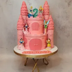 A fairytale dream come true, this two-tiered Disney princess castle cake was made for a second birthday. The towers and details are all handcrafted to create a magical centerpiece.