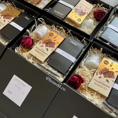 Another view of the client appreciation gifts for ShopSe, showing the careful arrangement of personalized and gourmet items within the sleek black boxes.