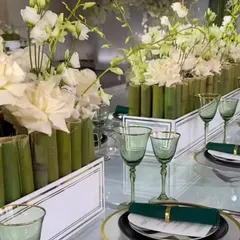 A modern and chic tablescape. We used clean white boxes filled with white flowers and bamboo shoots to create a minimalist and sophisticated centerpiece design.