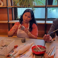 A student carefully carves details into her piece during a hand-building workshop. The focus and creativity in the room are always inspiring.