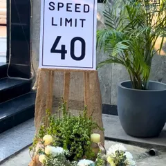 A creative decor element for a 40th birthday party, featuring a custom 'Speed Limit 40' sign. This shows how I incorporate fun, personal details into the event's ambiance.