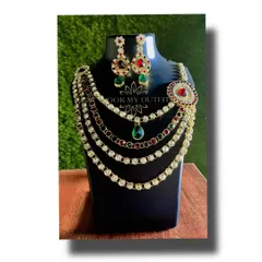 Make a statement at your next event with this multi-layered necklace. It combines rows of white stones with pops of red and green, making it a versatile piece that works for both weddings and parties.