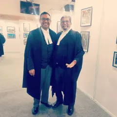 Sharing a light-hearted moment with a colleague at a legal event. A strong legal community is built on both serious work and collegial relationships.