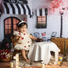 A first birthday celebration straight out of a Parisian dream. I design elaborate themed setups like this 'Cafe Paris' scene to make your baby's milestone truly unforgettable. We handle all the details, from the props to the cake, so you can just enjoy the moment.