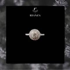 This double halo ring features a round brilliant cut diamond at its center, creating an effect of exceptional size and sparkle. It is a glamorous and elevated choice for your beloved.