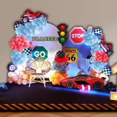 Another take on the racing theme for Praneel's first birthday. This setup includes a sleek red sports car prop, traffic signs, checkered flags, and a light-up number "1" on a track-style stage.