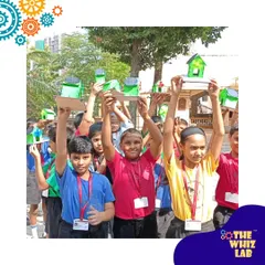 Harnessing the power of the sun! Students at New Activity School in Mumbai proudly display the solar-powered houses they built, complete with working fans.