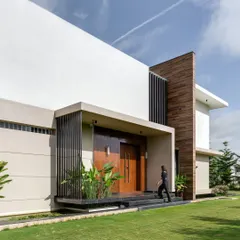 A closer view of the main entrance, where a floating platform and carefully placed plants guide the path. The design emphasizes a gentle transition from the expansive one-acre farm into the private sanctuary of the home.