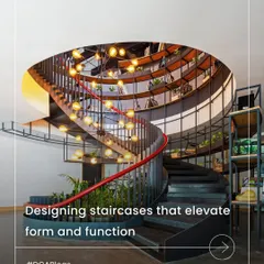 We approach staircases as architectural statements that define a project's identity. This dramatic spiral staircase, with its integrated lighting and shelving, is a sculptural form that elevates both form and function, transforming movement into an experience.