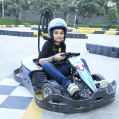 This young driver is focused and ready for his lap around the Tingaland Xtreme track. We ensure every child is safely strapped in before the race begins.