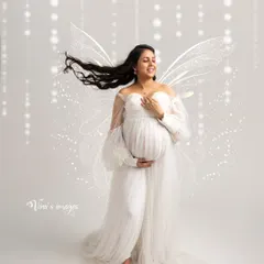Free-spirited and joyful. With ethereal wings and hair blowing in the wind, this portrait captures the pure bliss and liberating feeling of creating a new life.