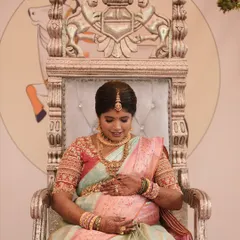 A beautiful, tender moment as the mother-to-be holds her belly. The soft colors of her saree are both calming and celebratory.