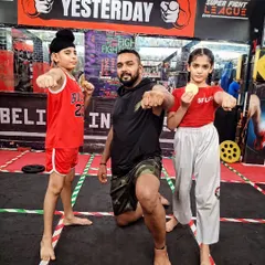 My little fighters. I teach them to be strong and confident. Here I am with two of my young students after they won medals in a competition.