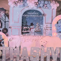 Thashvik's Winter Wonderland featuring life-sized polar bear props, a custom name display, and a backdrop of a snowy landscape to create a truly arctic feel.