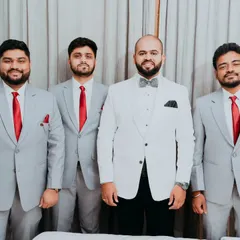 A classic formal portrait of the groom with his groomsmen, all looking dapper and ready to support him on his big day.