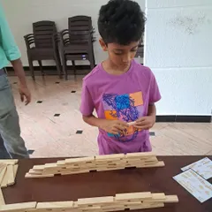 A young builder completely absorbed in his work. The desire to create materializes from imagination into action, building confidence with each plank placed. Our workshops are a space for quiet focus and flexible thinking.