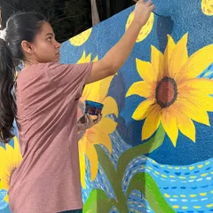 Here I am working on the swirling blue background, carefully recreating the iconic brushstroke style of the original 'Starry Night'.