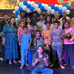 The whole family, including parents and siblings, celebrating at the gym. We encourage family involvement and create a welcoming space for everyone.