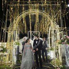 I created a grand, Gatsby-inspired entrance for this sangeet night. The golden arched tunnel with cascading metallic details and a black-and-gold patterned floor set a luxurious and celebratory tone for the evening.