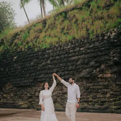Capturing pure joy during a pre-wedding shoot on the beach. The couple's white outfits and the natural setting create a fresh and candid feel.