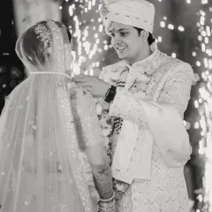 The sacred moment of the groom tying the mangalsutra, captured in classic black and white to emphasize its significance and timelessness.