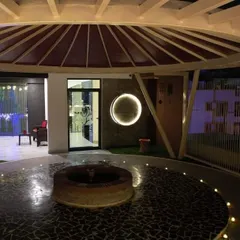 The serene outdoor area of our Bangalore centre at night, featuring the central fire pit. This space is designed for sacred rituals and peaceful contemplation under the open sky.