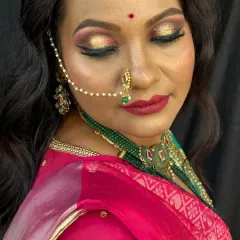 A close-up of a bridal makeup demonstration, highlighting the glitter cut-crease eye makeup and bold red lip. Our courses focus on such detailed techniques to help you create stunning and memorable bridal looks.
