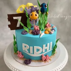 Let's find Nemo! This adorable cake was for a 7th birthday, featuring handmade Nemo and Dory toppers swimming among edible coral and seaweed. It’s a vibrant and fun underwater adventure.
