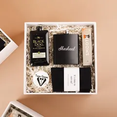 An overhead view of the groomsmen hamper, showing all the curated items neatly arranged. It's the perfect gift for the guys who planned the bachelor party.