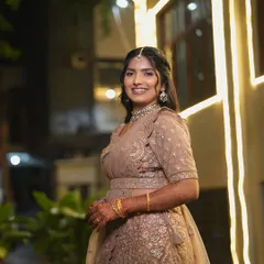 Vindya's reception look under the evening lights. The makeup has a soft shimmer to catch the light, perfect for a party atmosphere.