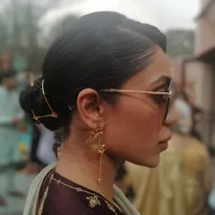 A sleek and modern hair updo, perfect for a wedding guest or a formal event. I used a beautiful gold hair accessory from Romana Singhani to add a touch of contemporary elegance to the classic bun.