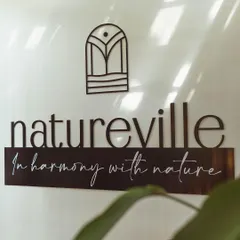 A close-up of our Natureville logo, which represents our ethos: "In harmony with nature." Every detail of our center is designed to create a peaceful and healing environment.