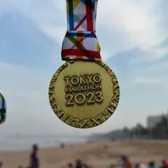 The Tokyo Marathon 2023 finisher medal. We help our runners prepare for international races, managing everything from training plans to race strategy.