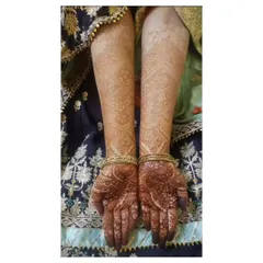 A complete view of the developed henna stain on both arms. This is the beautiful result of a detailed application and patient aftercare.