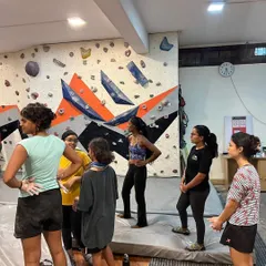 Another angle of our guided session, where participants get ready to practice what they've learned on the bouldering wall. The focus is always on learning and having fun.