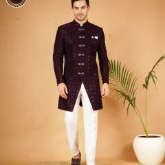A striking Indo-Western sherwani in deep purple, featuring a geometric pattern and ornate buttons. It's a powerful look for a groom who wants to blend tradition with a bold, modern statement.