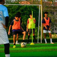 Here, we focus on the fundamentals. This training session shows our young players working on close ball control and dribbling around markers, a key drill to improve their first touch and confidence on the ball.