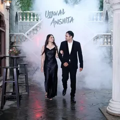 A cinematic shot of a couple walking through a smoky, classic European-style courtyard, creating a mysterious and romantic atmosphere.